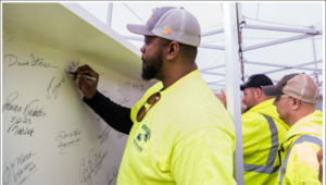 As part of the tradition, each of the 120 people gathered at Thursday’s celebration signed the final beam that will be placed atop the terminal roof