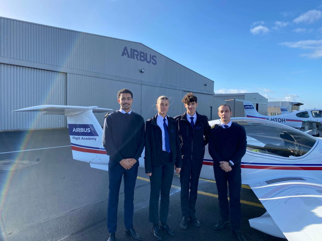 Airbus Flight Academy cadets with their flight instructor in front of an Elixir Aircraft.