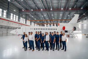 ExecuJet MRO employees in front of a Falcon 8X aircraft at the new facility © Dassault