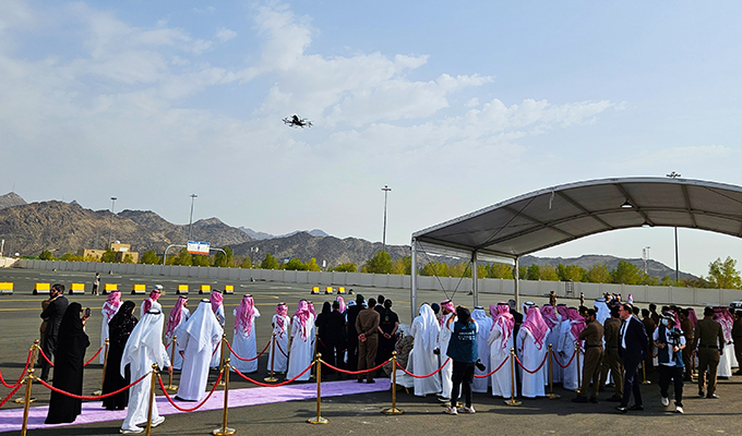 Guests witnessing the EH216-S pilotless eVTOL's debut flight in Saudi Arabia
