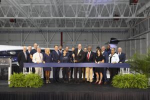 Community partners and Gulfstream leaders and employees gather at a ribbon-cutting ceremony to officially dedicate the Savannah Service Centre extension