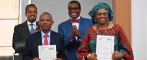 Ethiopian Airlines Group CFO Mensfin Tasew (left) and AfDB Vice President Nnenna Nwabufo display copies of the signed letter of intent