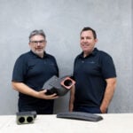 Plane Support Director of Engineering Jason Hazell and Director of Manufacturing and Maintenance Fraser Wright holding 3-D printed 214B helicopter parts